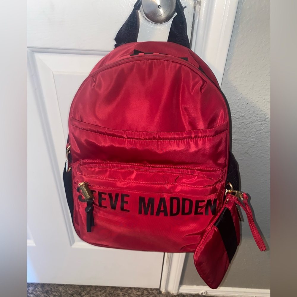Red and black backpack with small bag.